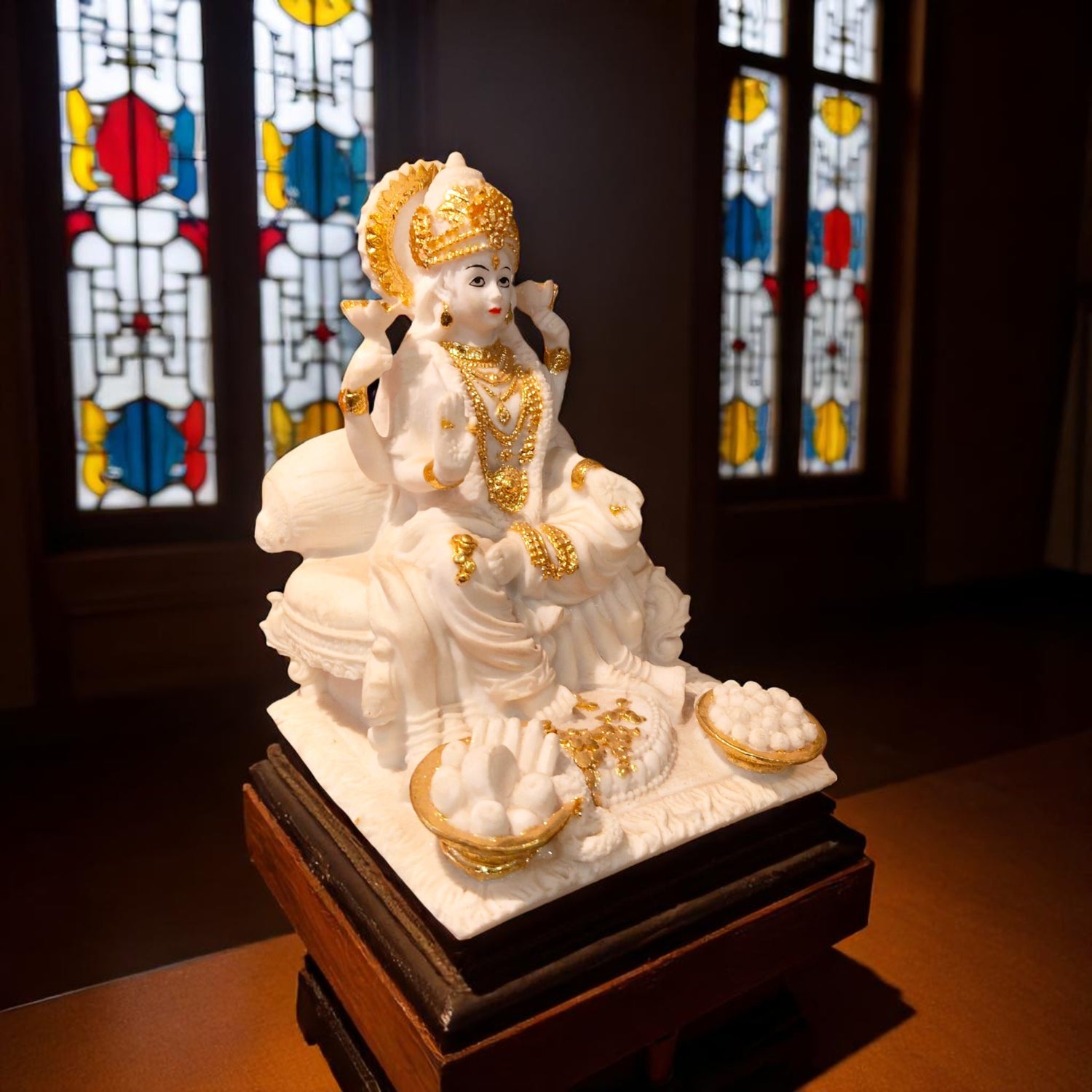 Side view of Maa Lakshmi idol on decorative throne with gold detailing