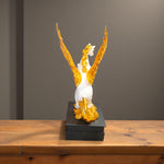  Side profile of white and gold flying horse statue