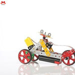 Toy mechanical model of a vehicle with red wheels on a white background