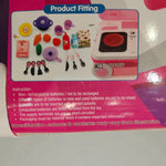 Close-up of included toy kitchen accessories like pans, cups, utensils, and pretend food items.