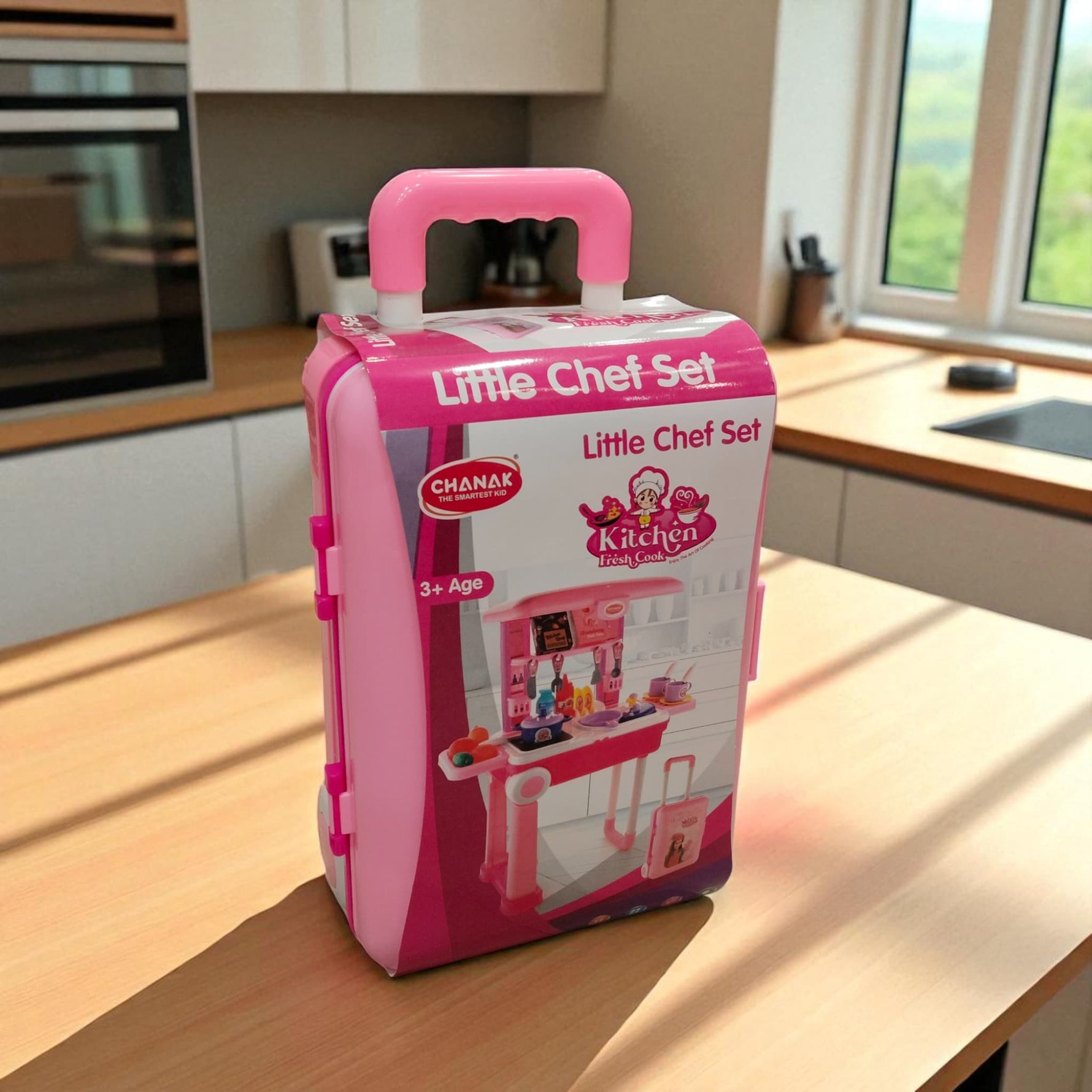 Front view of Little Chef Set toy kitchen suitcase with kitchen illustration on packaging.