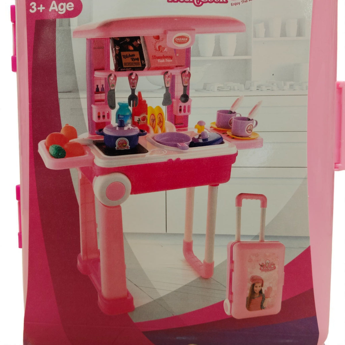 Pink and purple toy kitchen set close-up showing stove, utensils, play food, and cooking accessories.