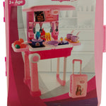 Pink and purple toy kitchen set close-up showing stove, utensils, play food, and cooking accessories.
