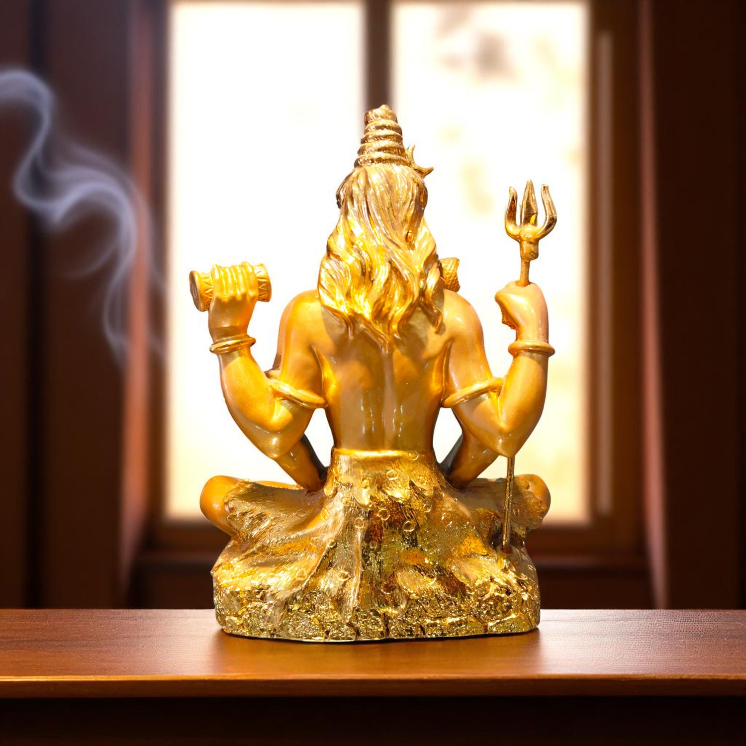 Rear view of Shiva idol showing golden hair details and trident positioning