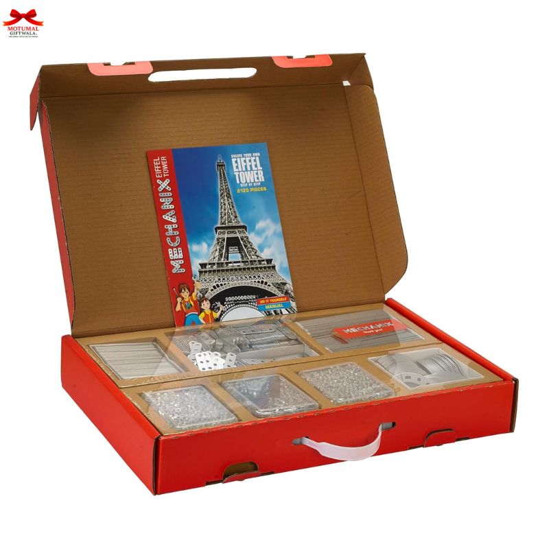 Open box containing card games with a prominent Eiffel Tower design on the cover.