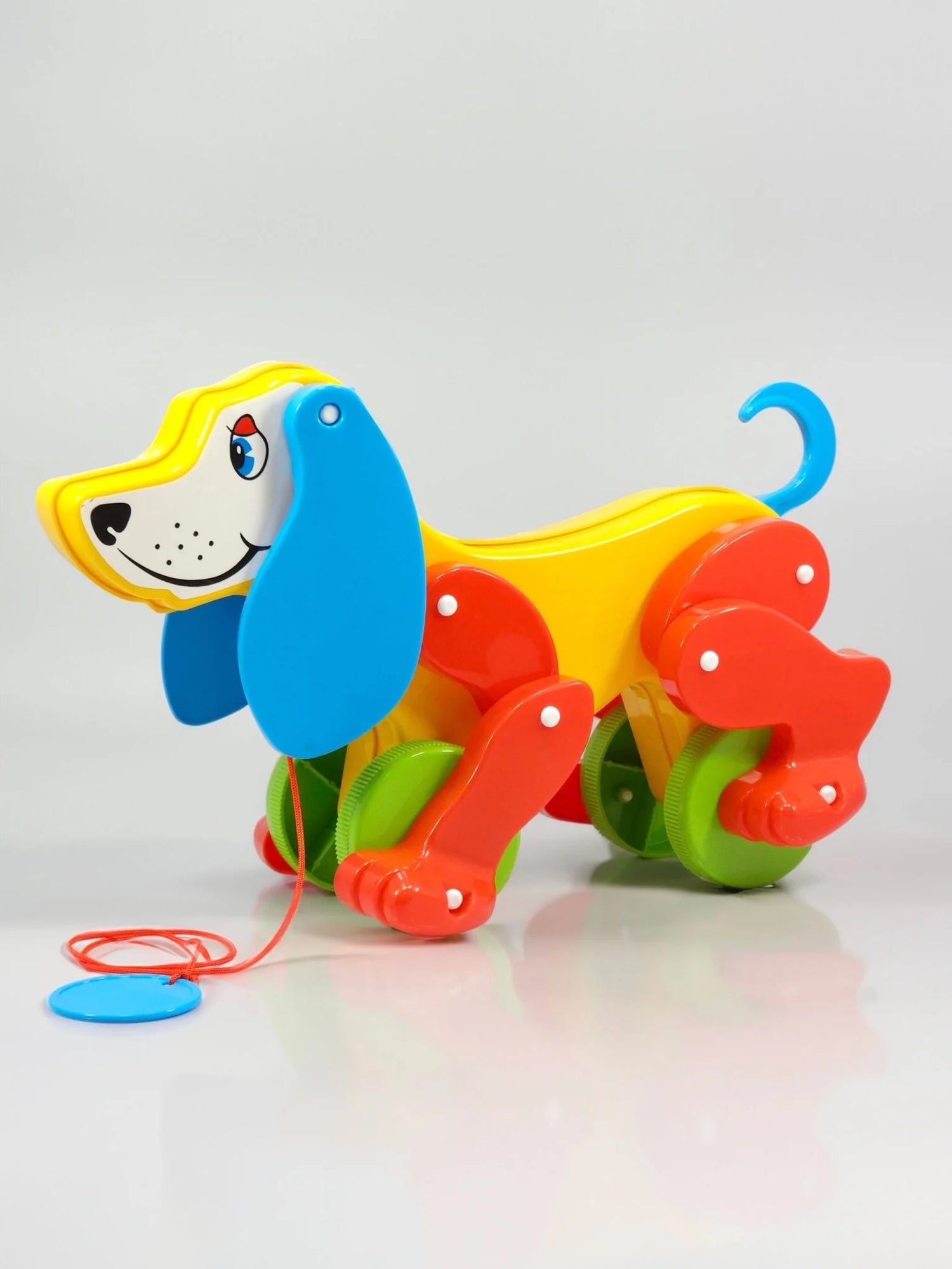 Colorful toy dog with wheels on a white background