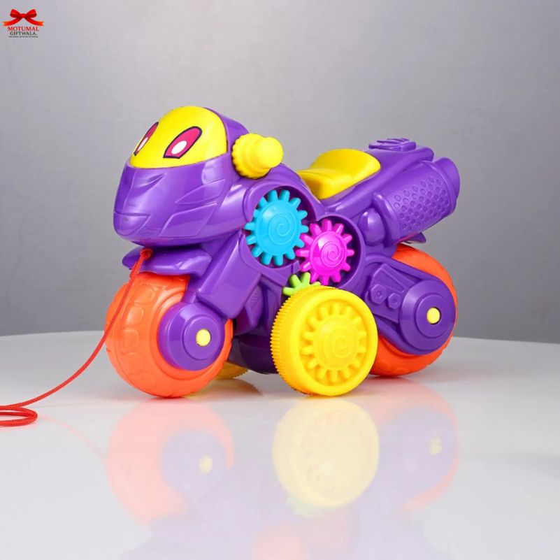 Colorful toy motorcycle with gears on a reflective surface and gray background
