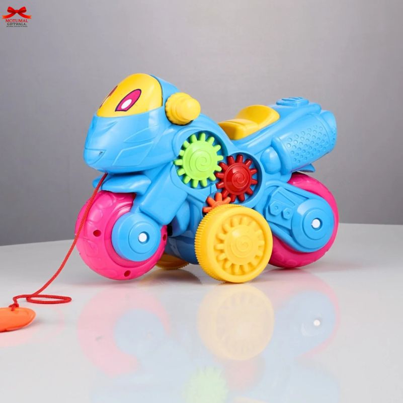 Colorful toy motorcycle with gears on a reflective surface and gray background