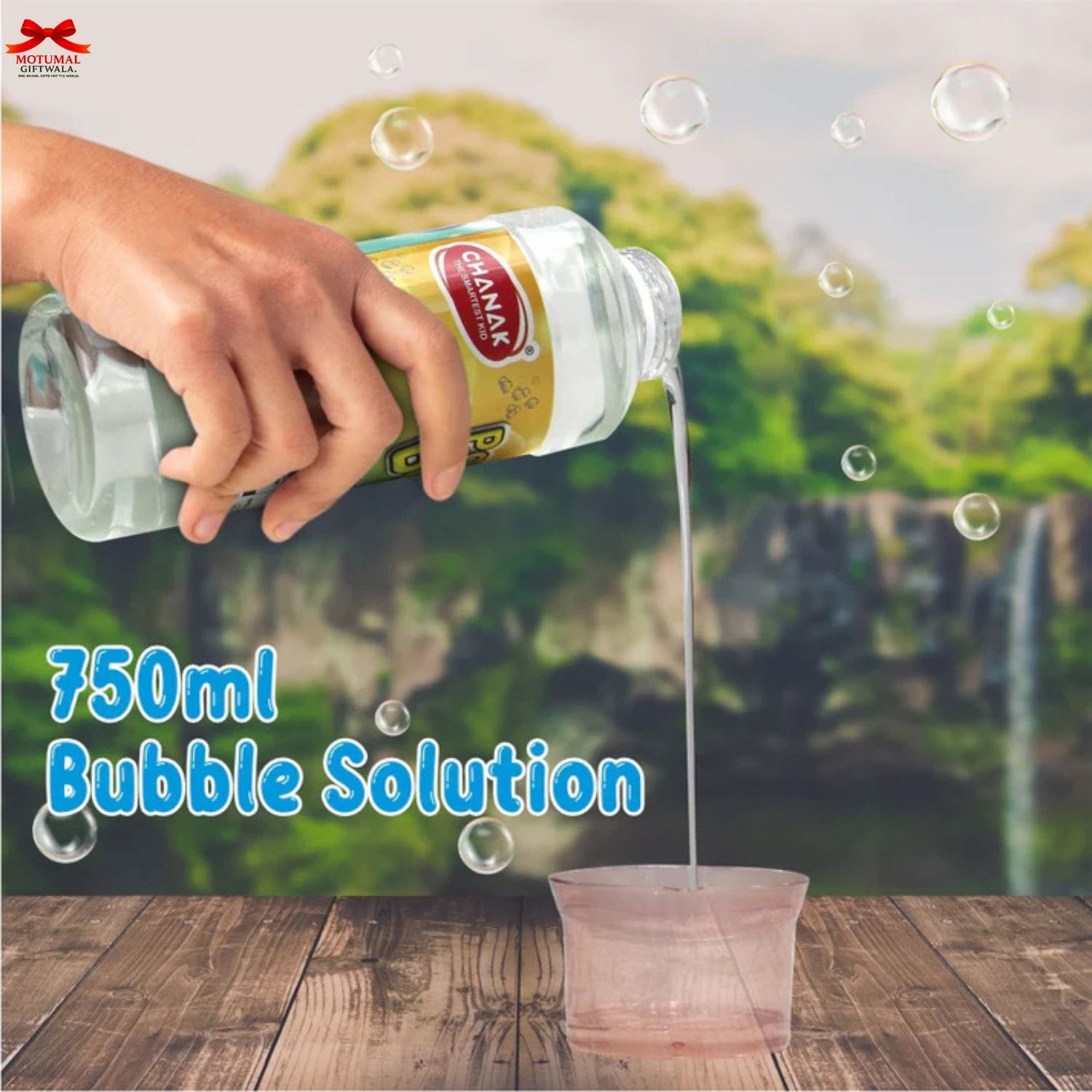 Hand pouring bubble solution from a bottle labeled 'Denak' into a container with a scenic background.