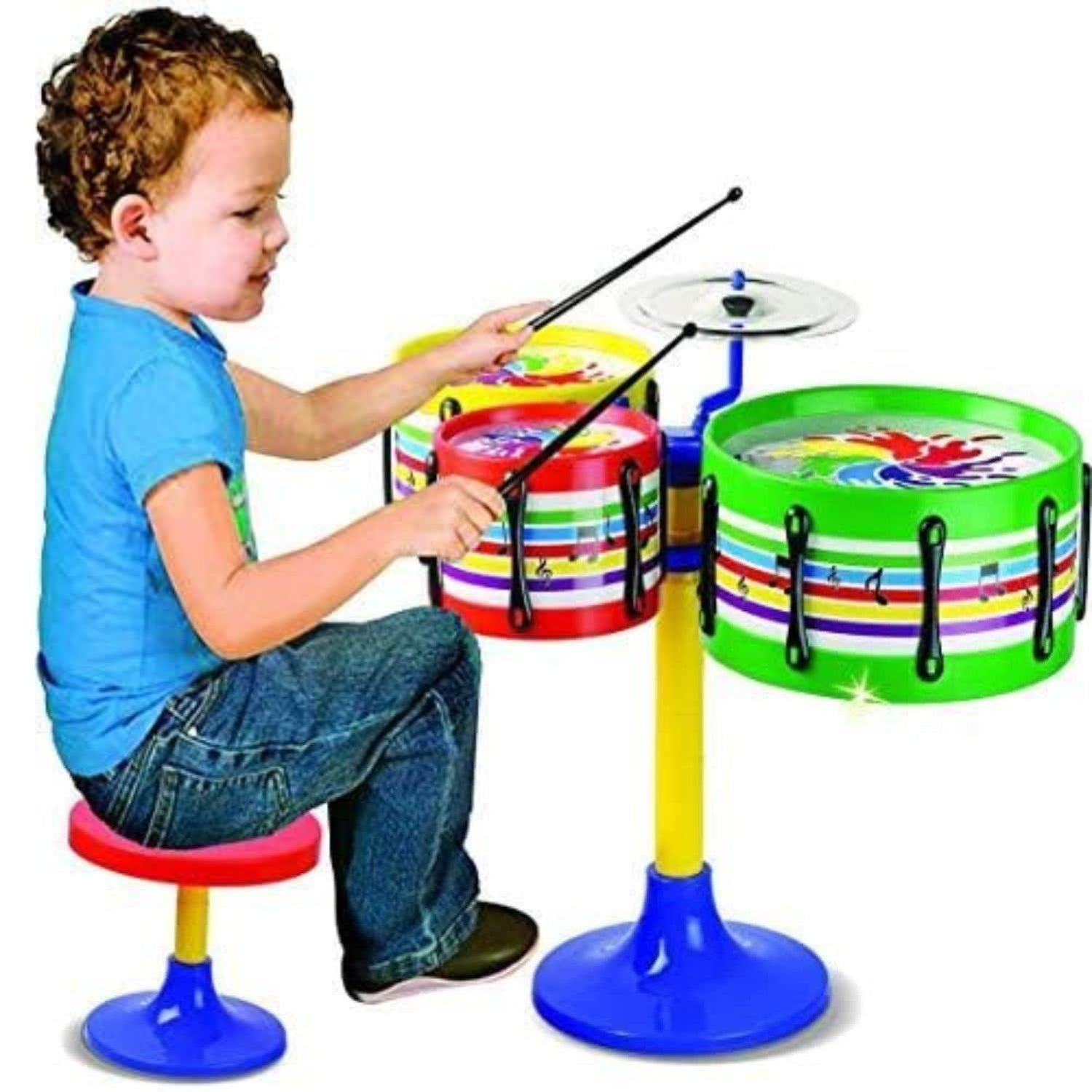 Child playing with a colorful toy drum set on a white background