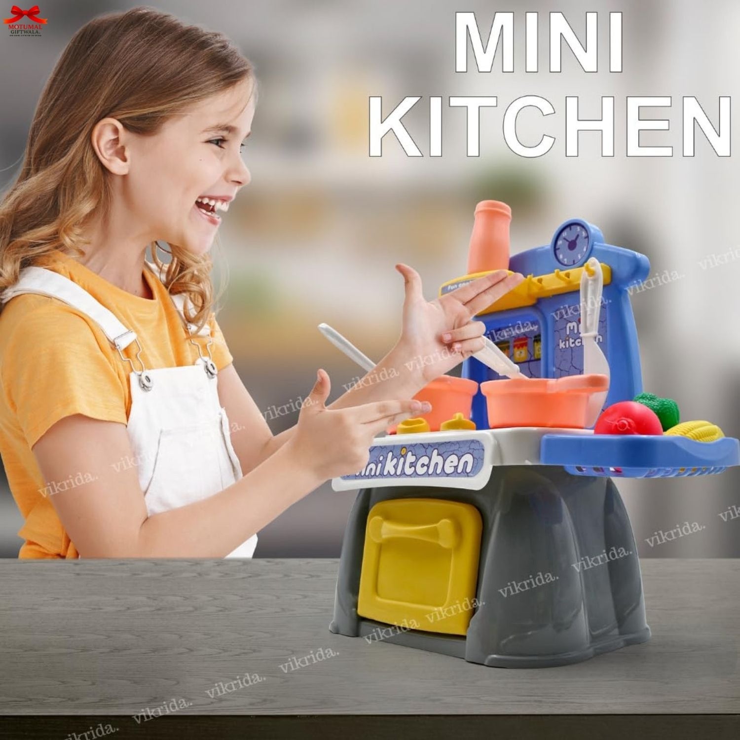 Child playing with a toy kitchen set on a table, with 'Mini Kitchen' text above.