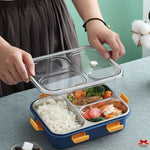 Person opening a bento box with compartments filled with food on a table.