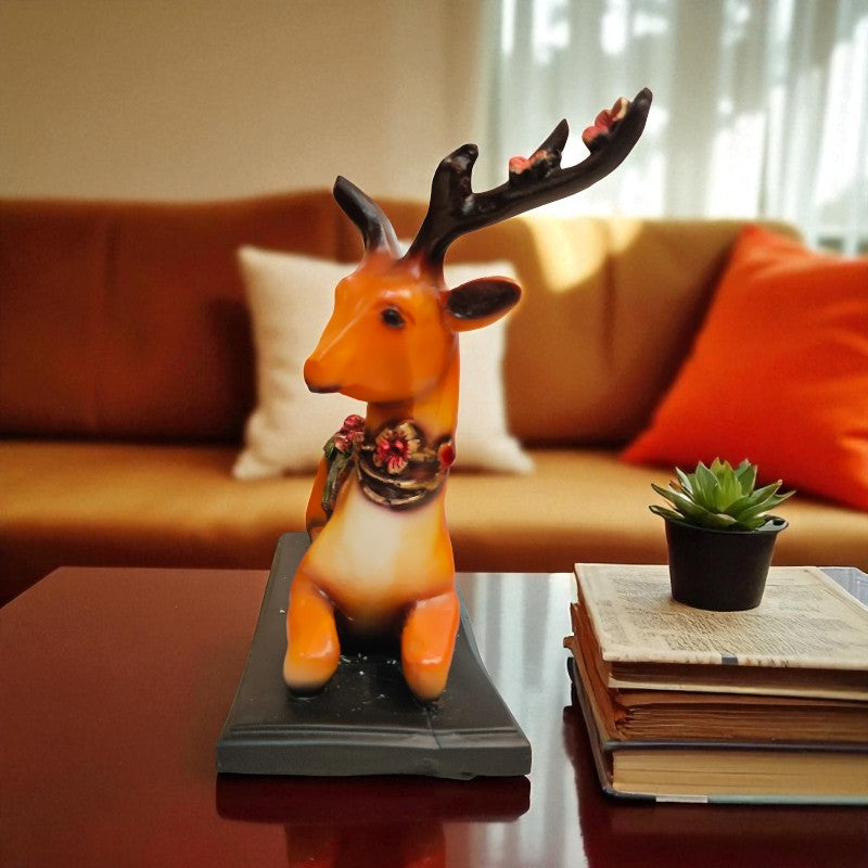 Decorative deer figurine on a table with a couch and books in the background