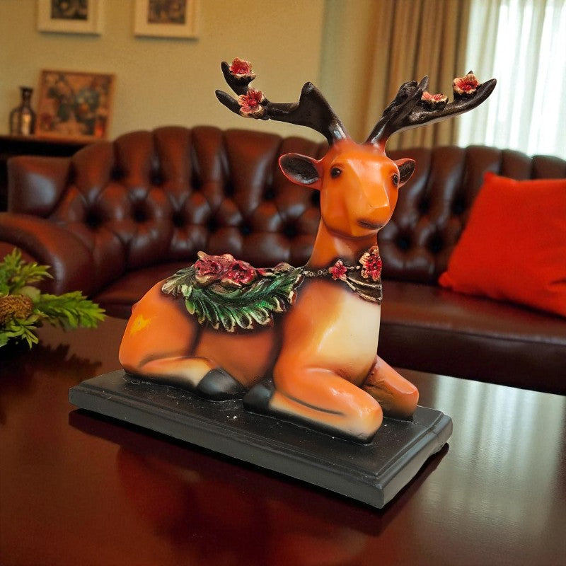 Decorative reindeer figurine with flowers on a table in a living room.