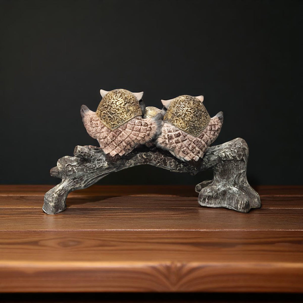 Back side of owl family resin decor piece with golden detailing