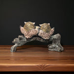 Back side of owl family resin decor piece with golden detailing