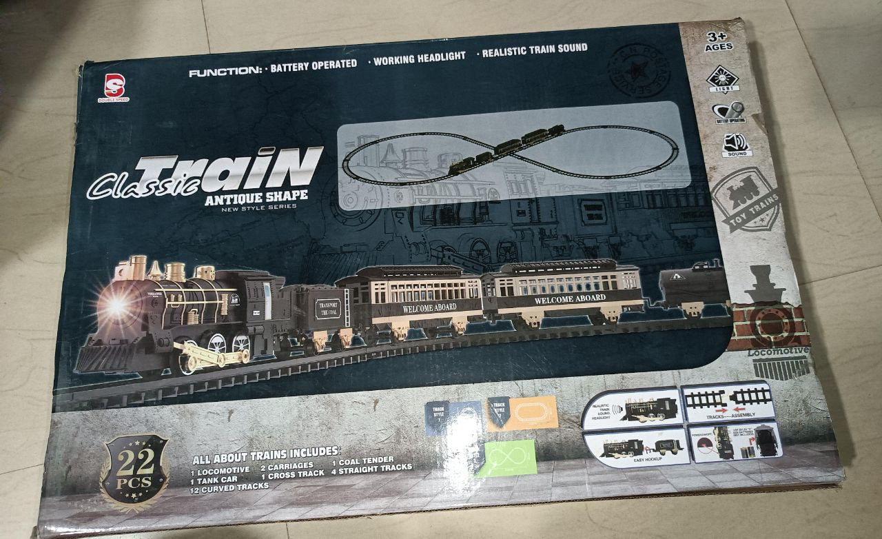 Boxed train set with model train layout on a light-colored floor