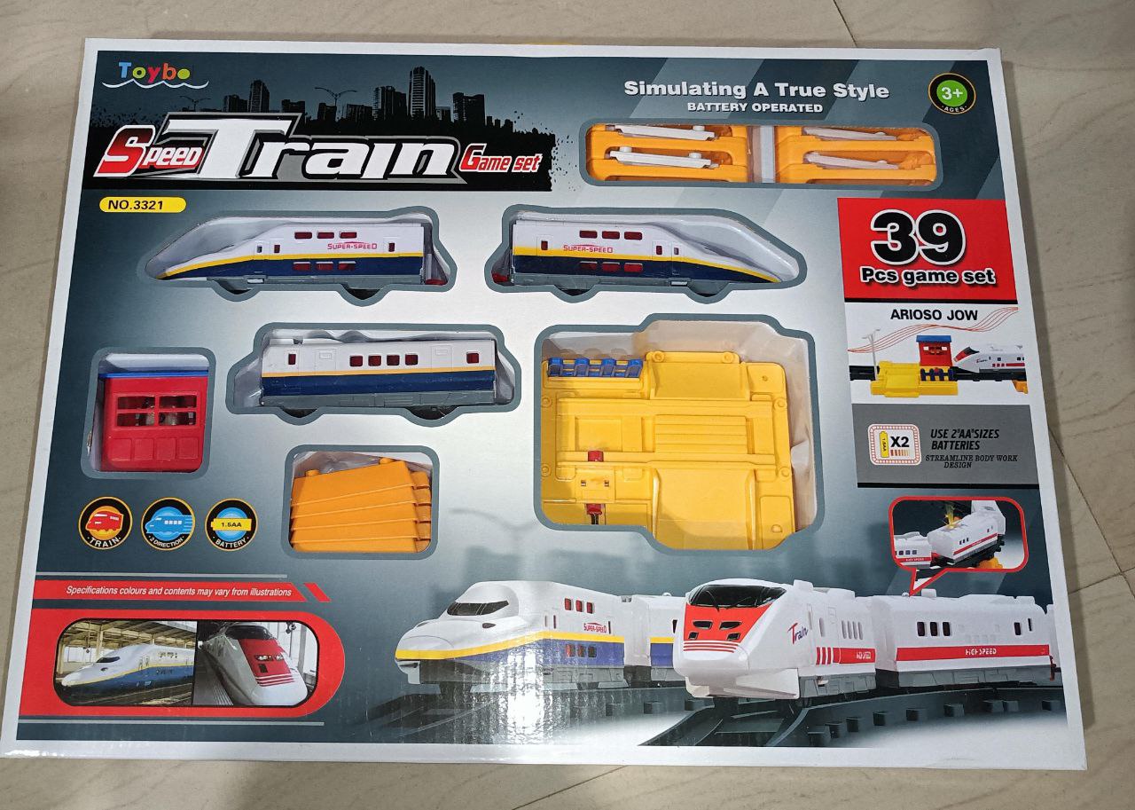 Toy train set packaging with multiple train models and accessories on a gray background