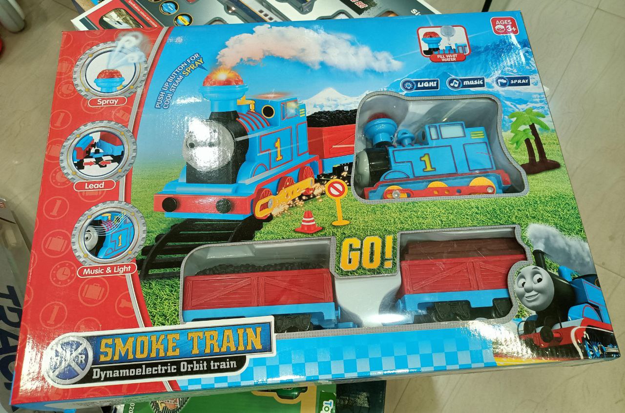 Toy train set with 'Smoke Train' branding on a colorful box