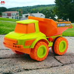 Toy dump truck with 'Rambo Dumper' on a paved surface outdoors.