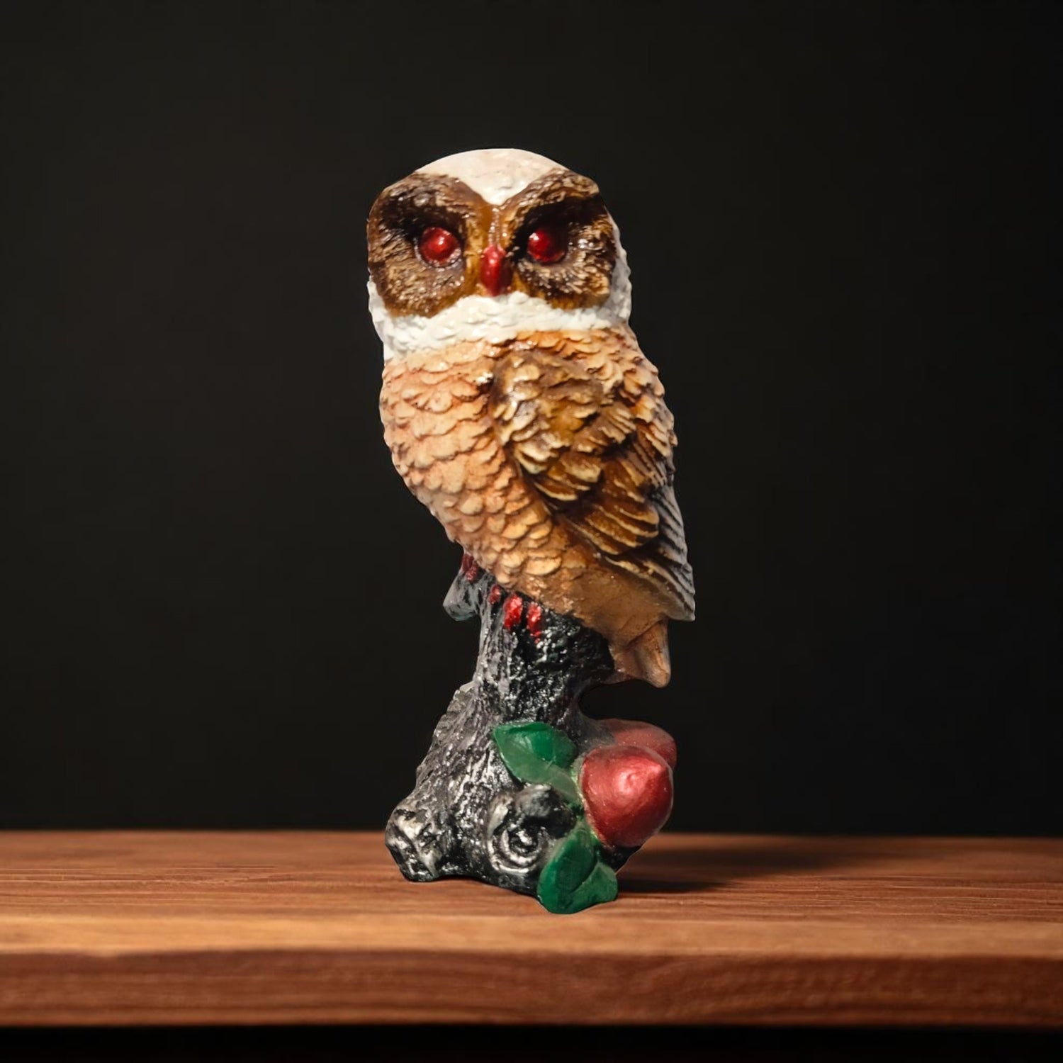 Front view of red-eyed owl showpiece sitting on fruit base
