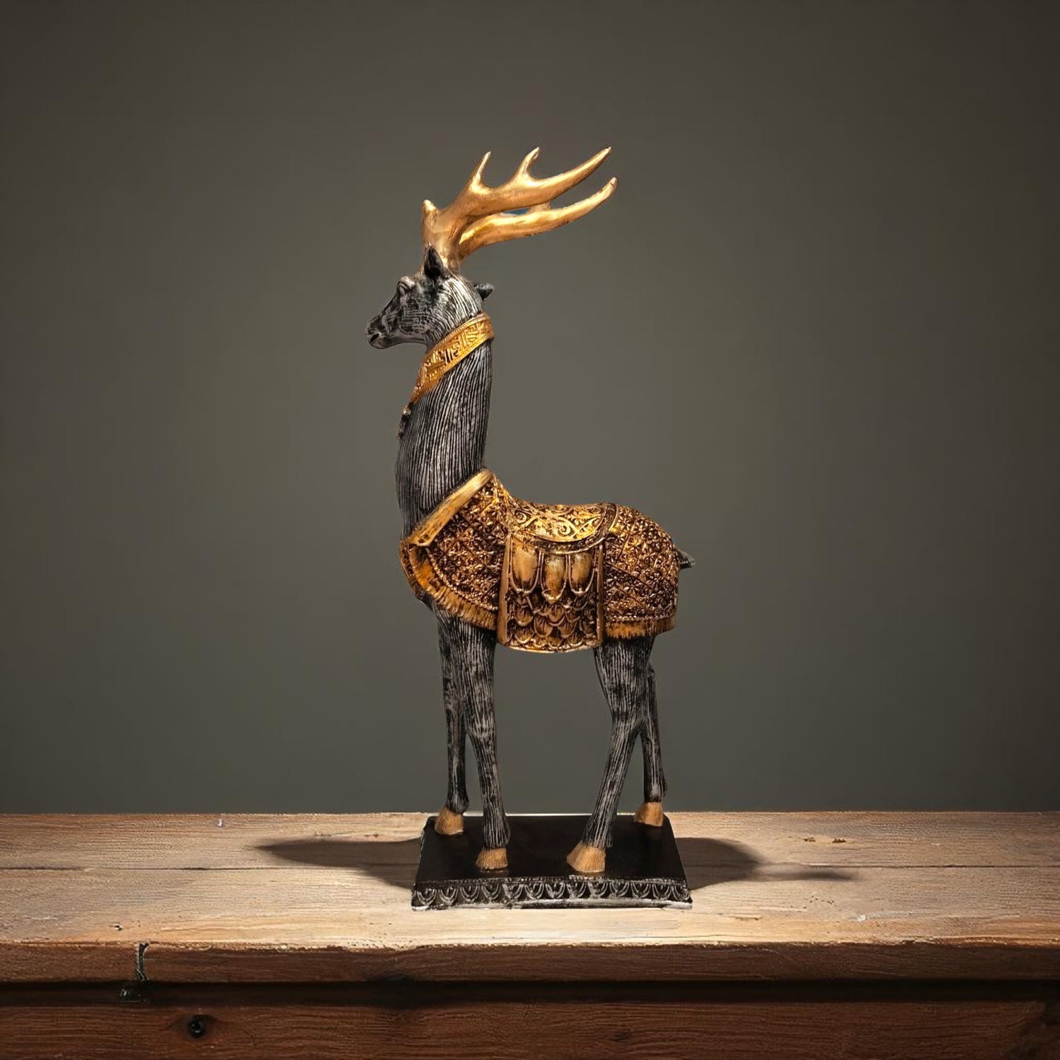 Left profile of handcrafted golden deer showpiece on wooden table.