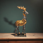 Side view of black and golden antlered deer showpiece for royal home decor.