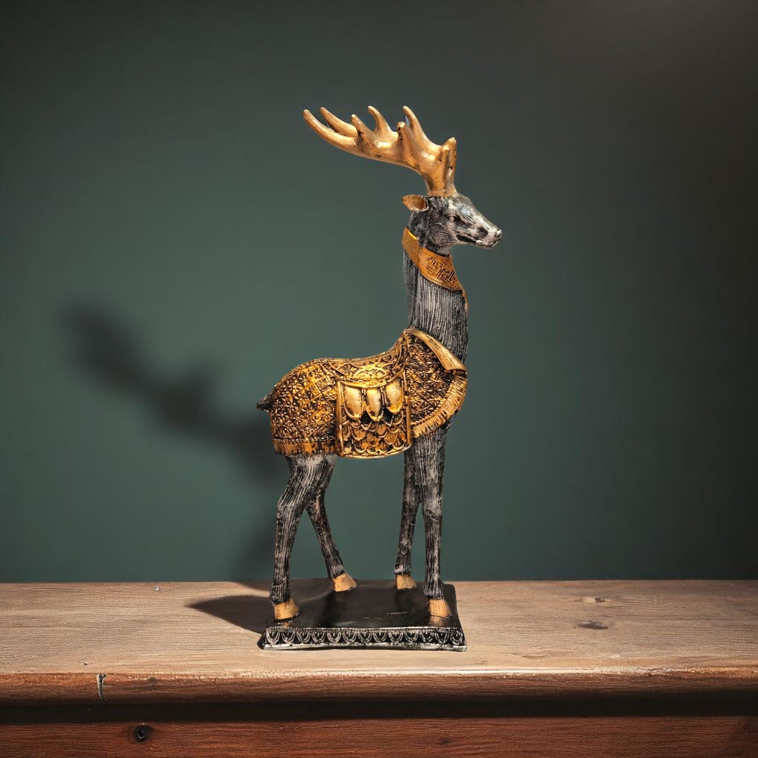 Side view of black and golden antlered deer showpiece for royal home decor.