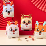 Orange and yellow cartoon reindeer piggy banks with antlers and smiling faces, ideal kids gift by Motumal Giftwala