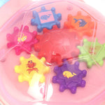 Colorful bath toys with sea creature designs in a pink container