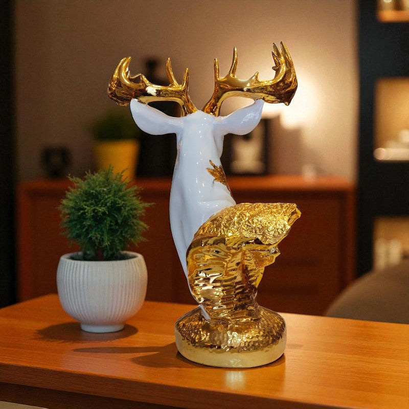 Decorative deer statue with gold accents on a table in a living room setting.