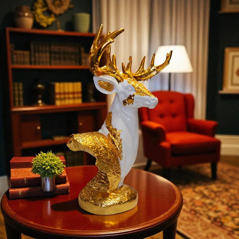 Decorative deer statue with gold accents on a table in a living room setting.