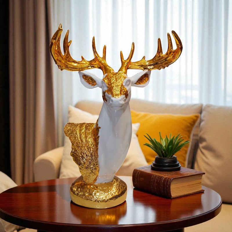 Decorative deer head with gold antlers on a table in a living room setting