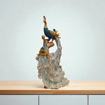 Decorative figurine of a peacock on a stand with a plain background
