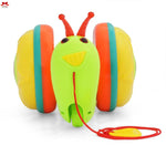 Colorful toy caterpillar with a red string on a white background