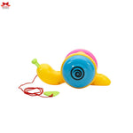 Colorful toy snail with a red string on a white background