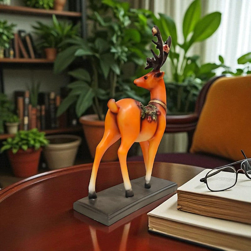 Decorative deer figurine on a table with books and glasses in a home setting