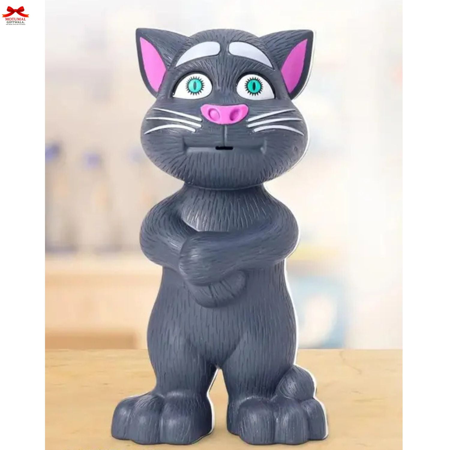 Gray cat-shaped figurine with arms crossed on a blurred background