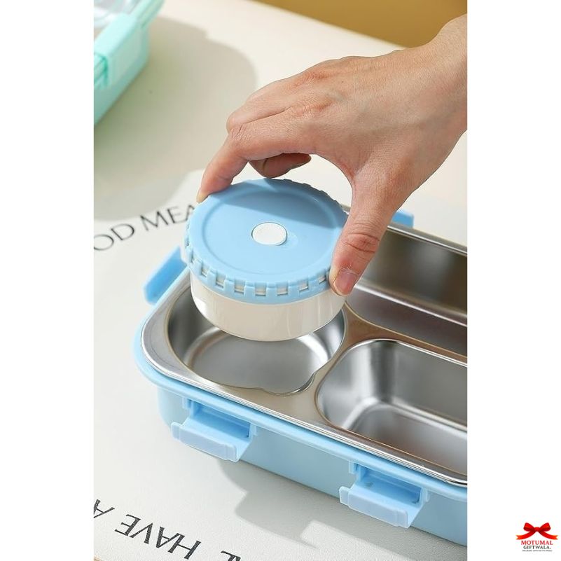 Hand placing a small blue container into a larger blue and silver lunch box.