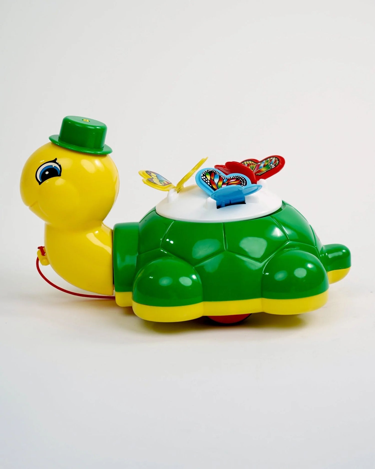 Toy turtle with a green shell and yellow body on a white background