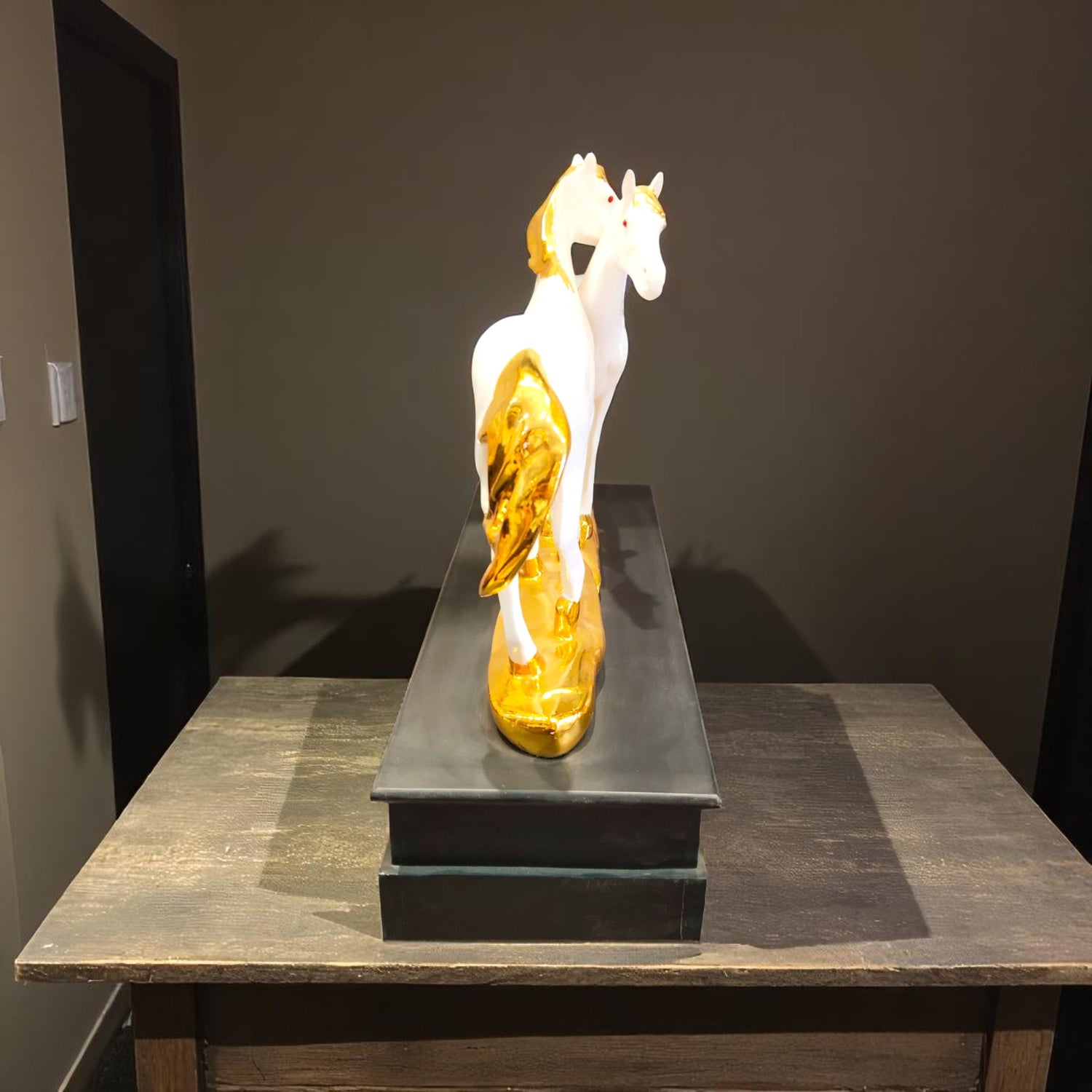 Rear view of the golden-tailed twin horse showpiece