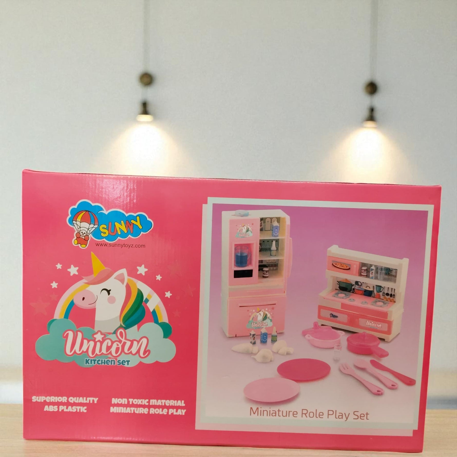 Back side of the Unicorn Kitchen Set box showing miniature role play setup with fridge, stove, plates, and small kitchen items.