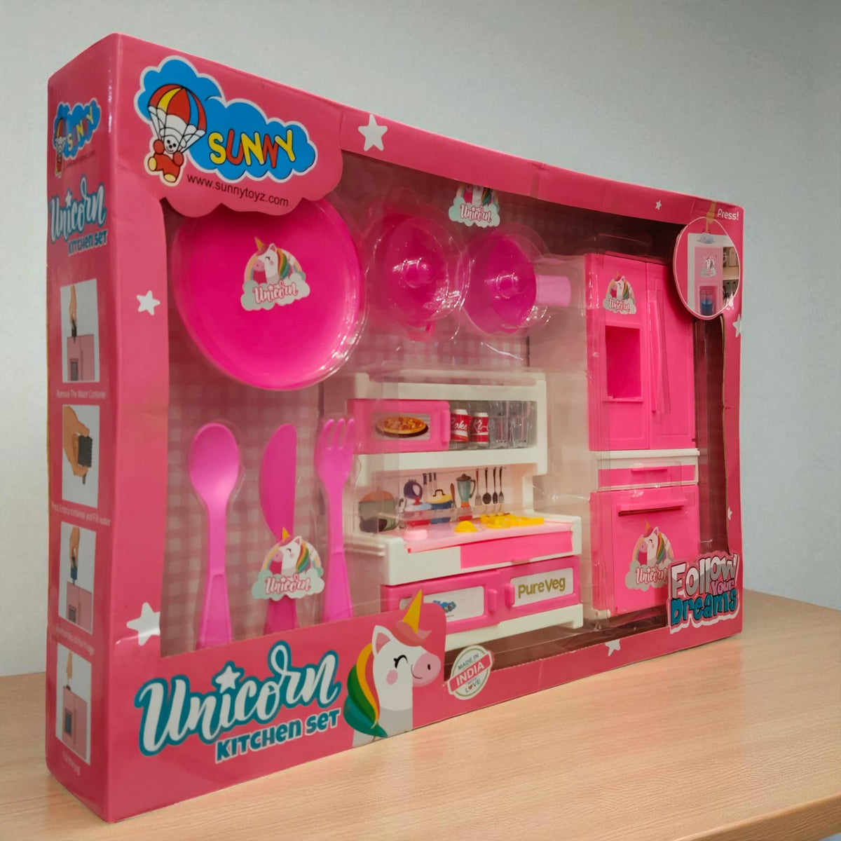 Side angled view of the Unicorn Kitchen Set toy box showing pink kitchen accessories and utensils with unicorn theme branding.