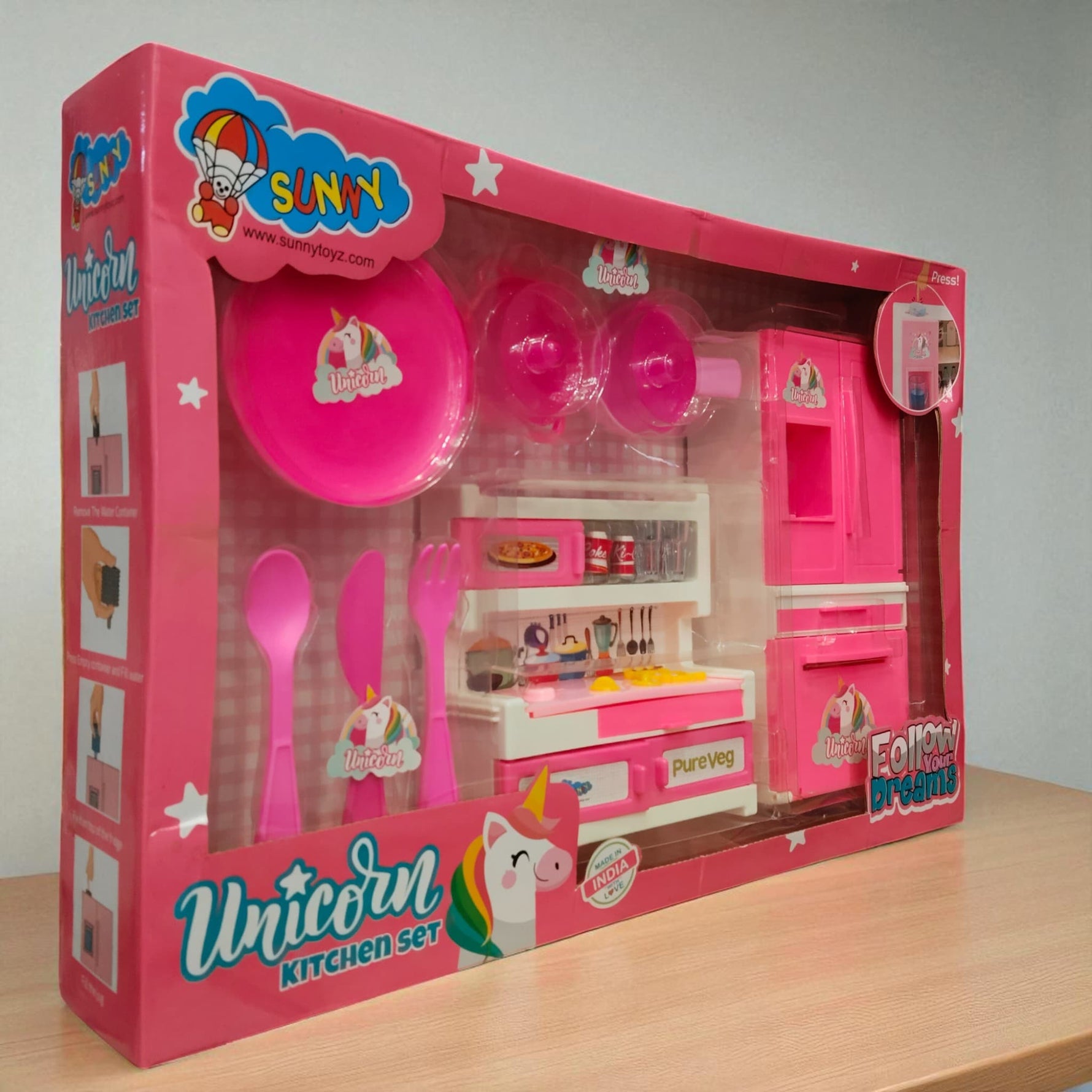 Side angled view of the Unicorn Kitchen Set toy box showing pink kitchen accessories and utensils with unicorn theme branding.