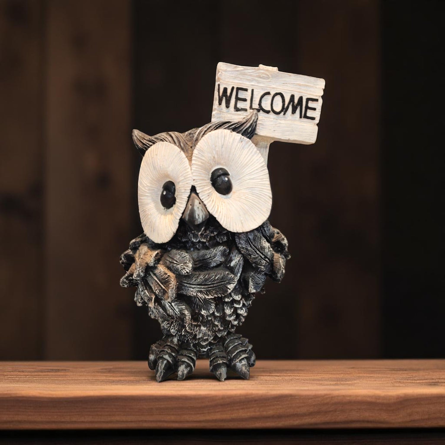 Front view of cute owl showpiece holding welcome sign