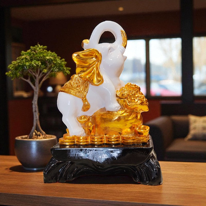 Decorative statue of a lion with gold accents on a dark base, placed on a wooden surface.