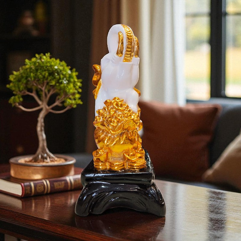 Decorative statue on a table with a blurred indoor background