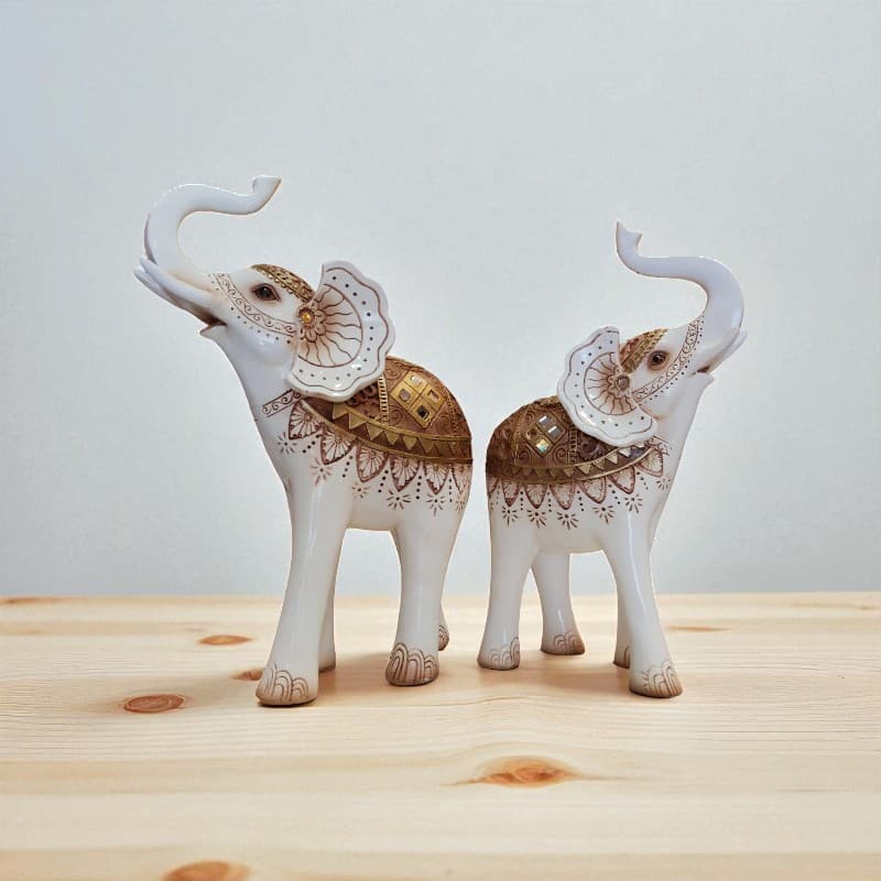 Decorative elephant figurines with intricate patterns on a wooden surface