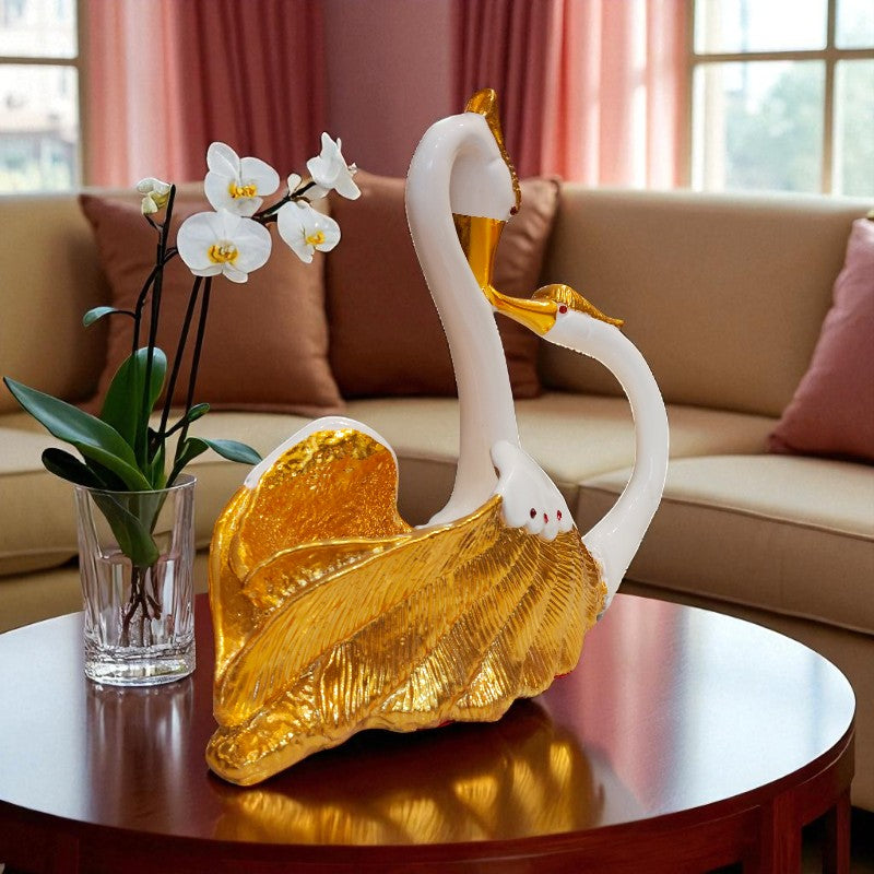 Decorative swan sculpture with gold accents on a table in a living room setting.